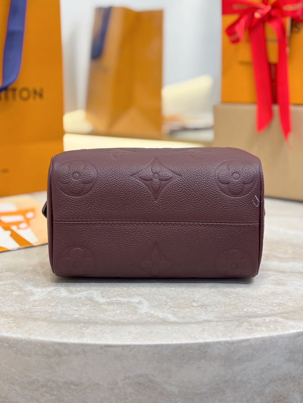 Louis Vuitton maroon leather small bag with flap and embossed monogram pattern