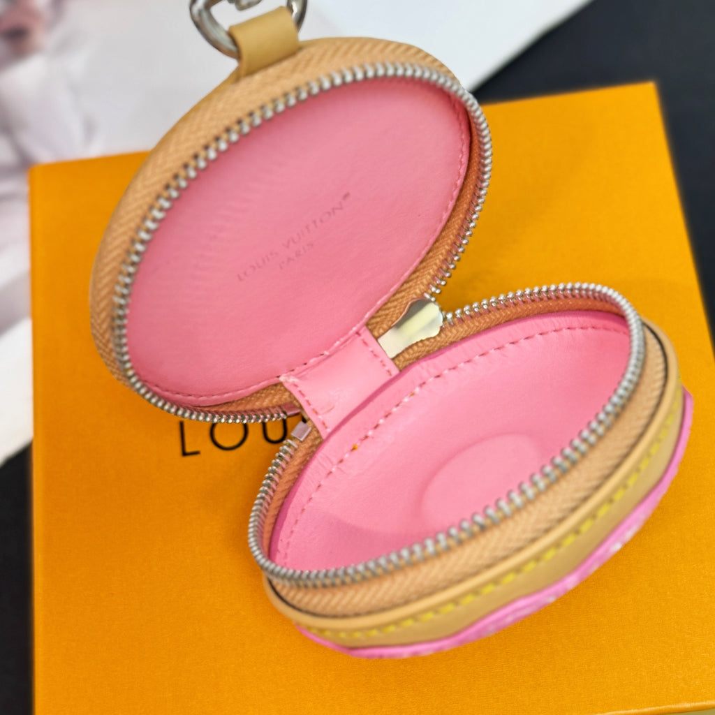 Open round key pouch showing pink interior lining and gold zipper trim