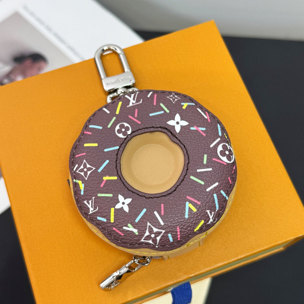 Donut-shaped key pouch in dark canvas with multicolor design and metal clasp