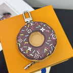 Donut-shaped key pouch in dark canvas with multicolor design and metal clasp