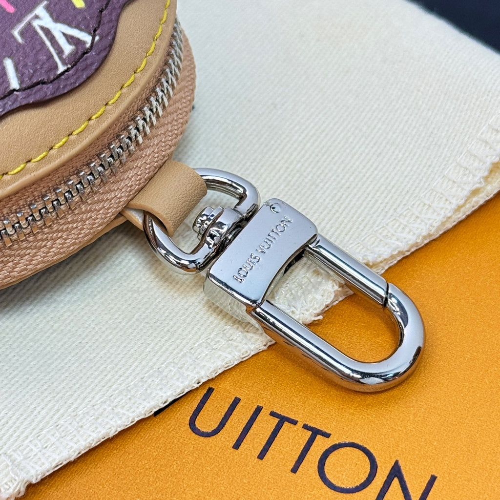 Silver lobster clasp on beige leather key pouch strap with zipper edge