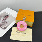 Louis Vuitton donut key pouch keychain with pink monogram pattern on cream dust bag
