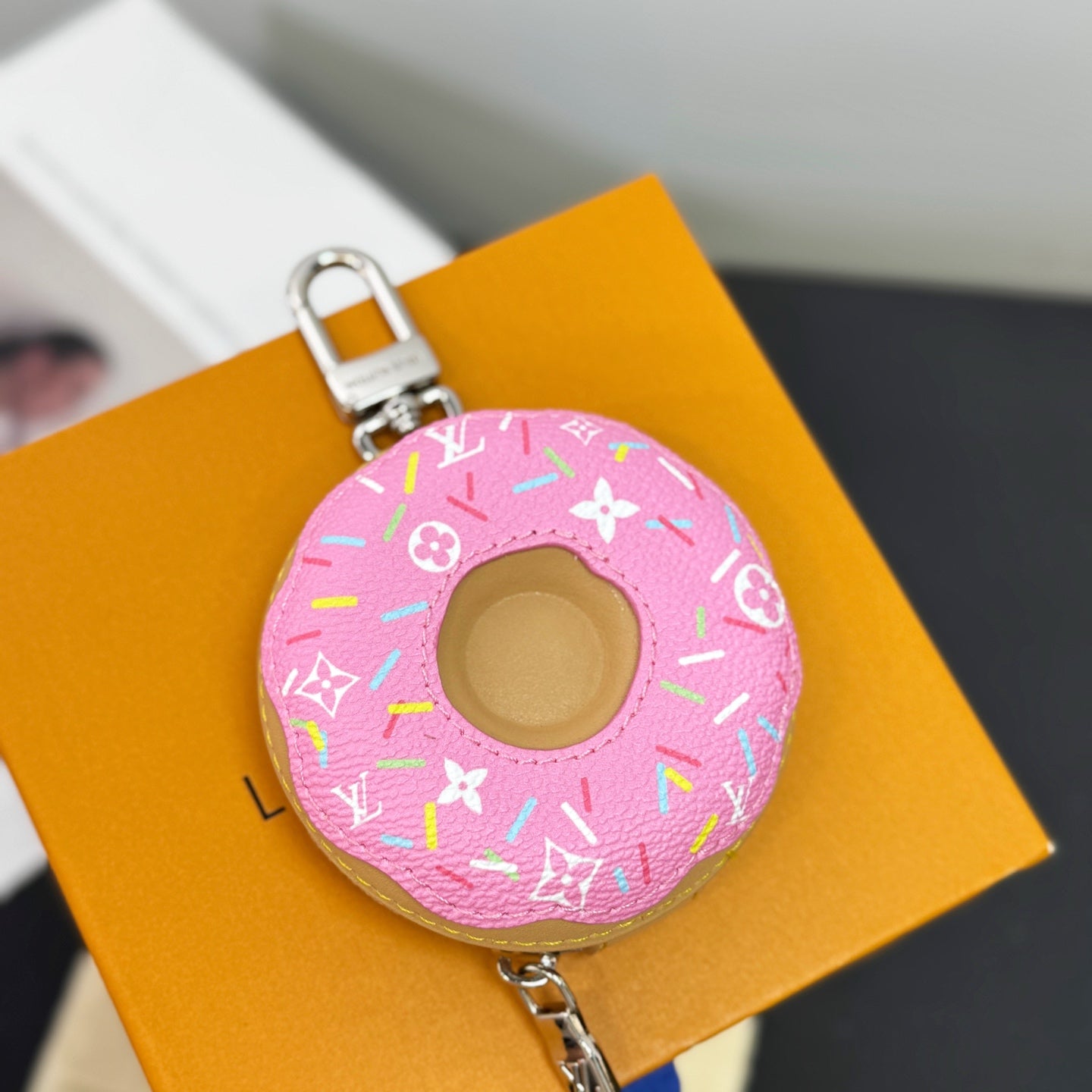 Louis Vuitton pink donut key pouch charm with monogram print and silver clasp