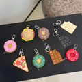 Assorted keychains with colorful monogram patterns, each with metal clip