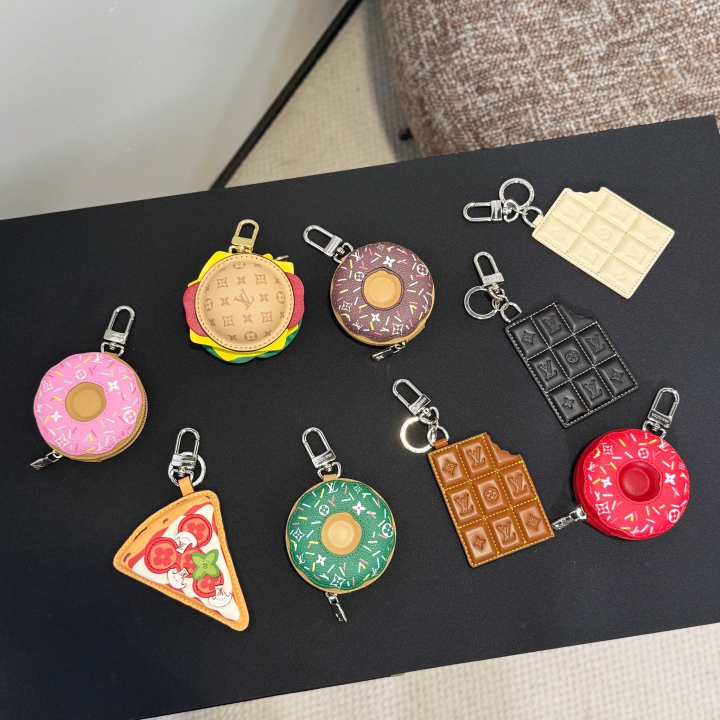 Assorted keychains with colorful monogram patterns, each with metal clip