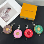 Donut-shaped keychains in purple, pink, red, and green with metal clips