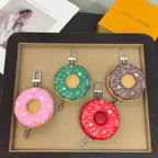 Boxed donut-shaped keychain set in green, purple, pink, and red with metal clips