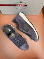 Dark blue suede lace-up sneakers with white midsoles and thick tread