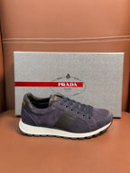 Dark blue suede lace-up sneakers with round logo patch and white sole