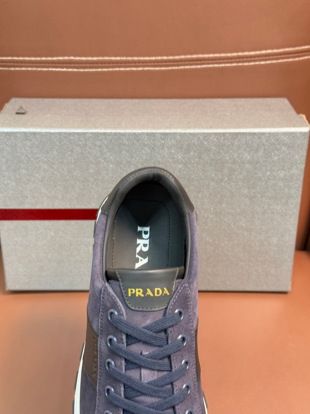 Dark blue suede lace-up sneakers with Prada logo on the tongue