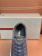 Dark blue suede lace-up sneakers with Prada logo on the tongue