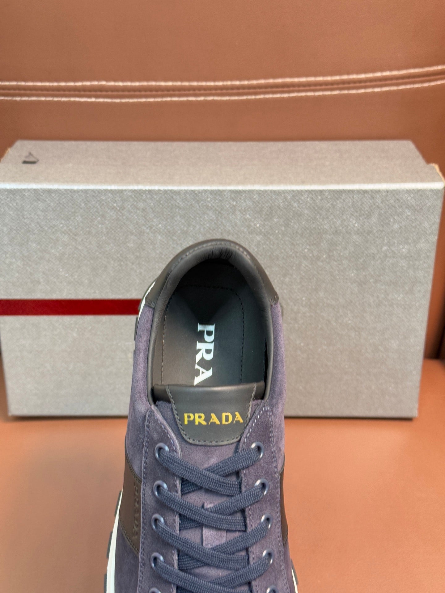 Dark blue suede lace-up sneakers with Prada logo on the tongue