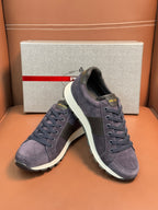 Dark blue suede lace-up sneakers with white rubber sole, side view