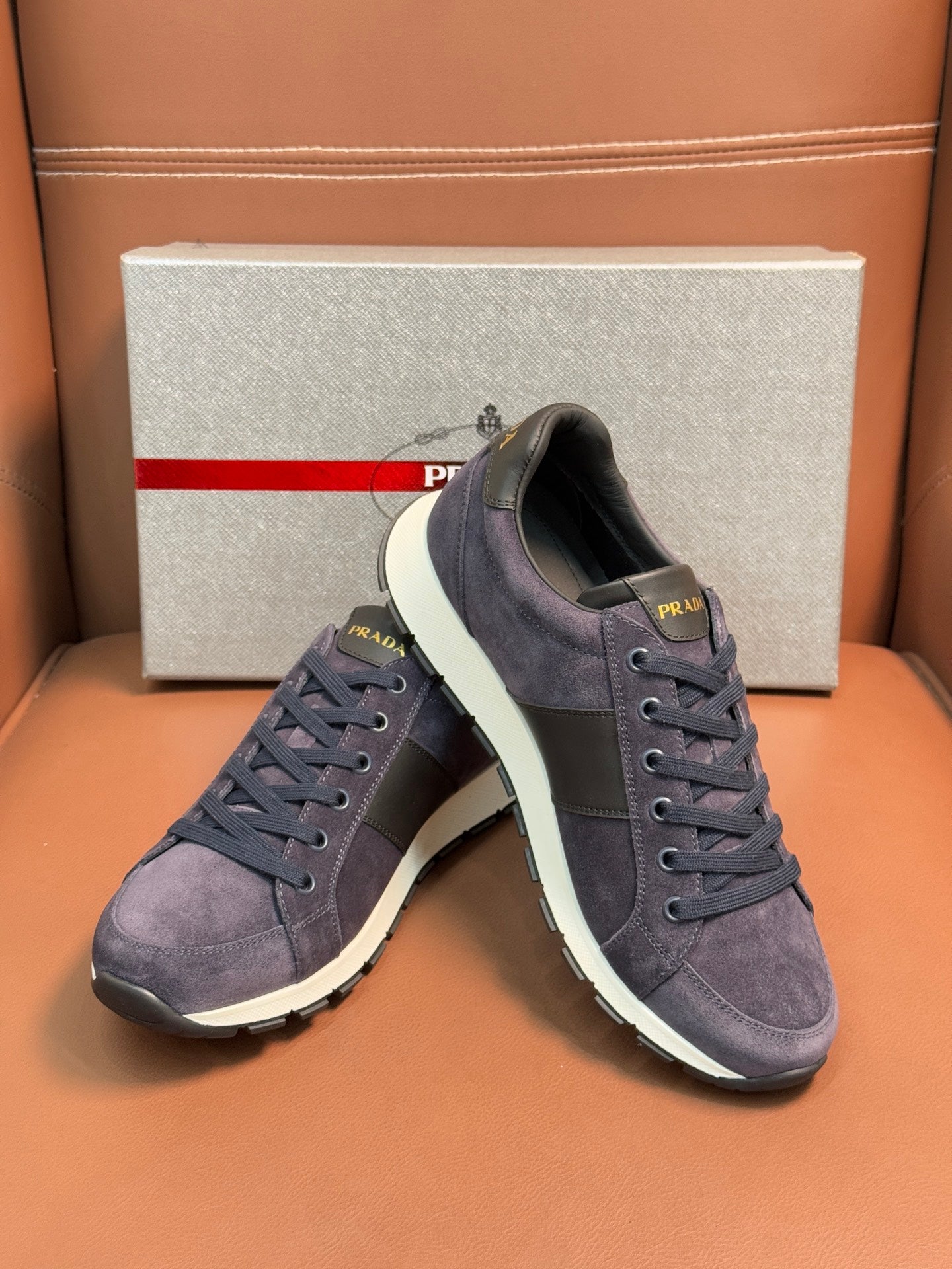 Dark blue suede lace-up sneakers with white rubber sole, side view