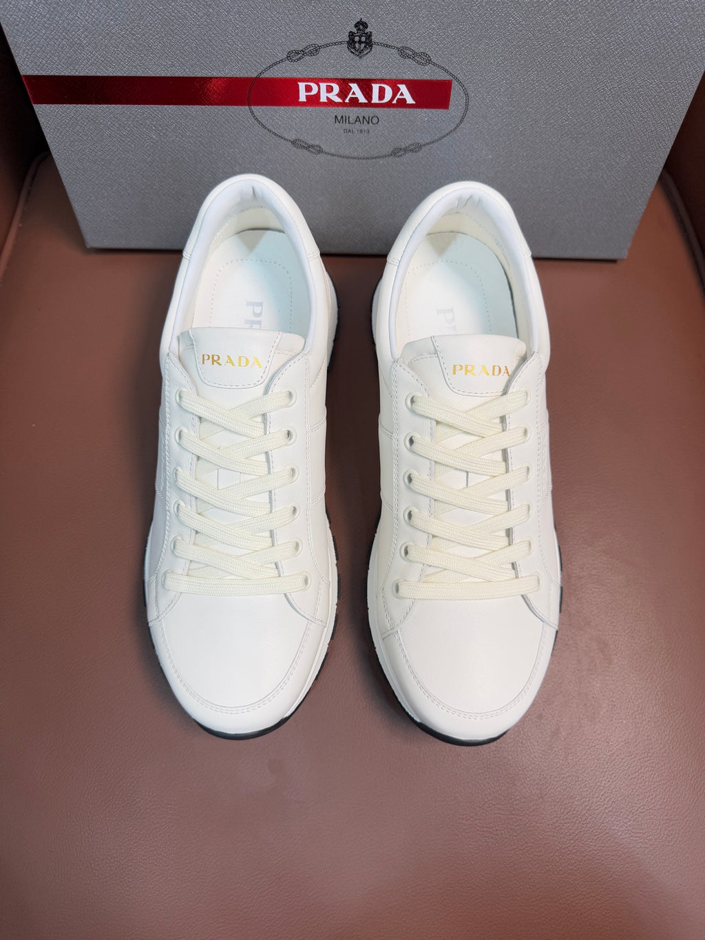 White lace-up low-top sneaker with rubber sole, Prada logo on tongue