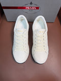 White lace-up low-top sneaker with rubber sole, Prada logo on tongue