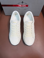 White lace-up low-top sneaker with rubber sole, Prada logo on tongue