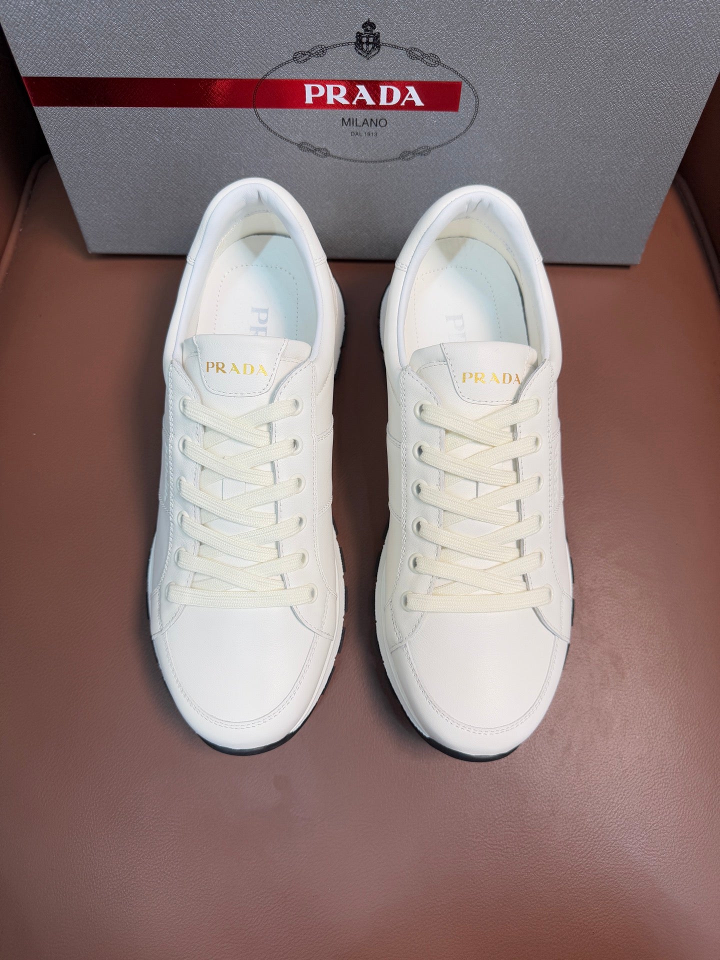 White lace-up low-top sneaker with rubber sole, Prada logo on tongue