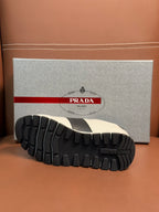 Black tread outsole of Prada unisex sneaker with ribbed grip pattern