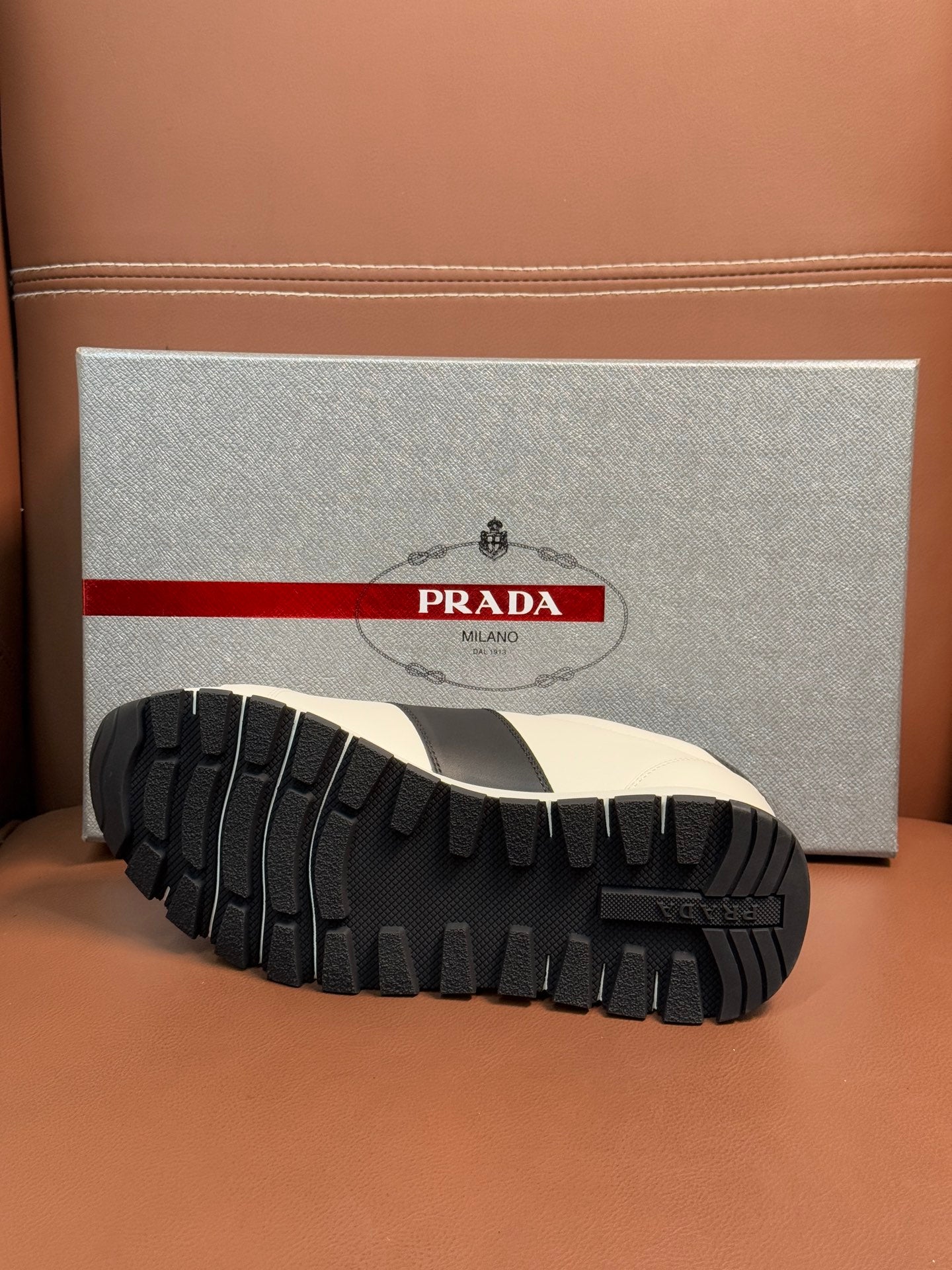 Black tread outsole of Prada unisex sneaker with ribbed grip pattern