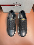 Prada unisex sneakers, dark leather upper with lace-up front and stitched toe detail