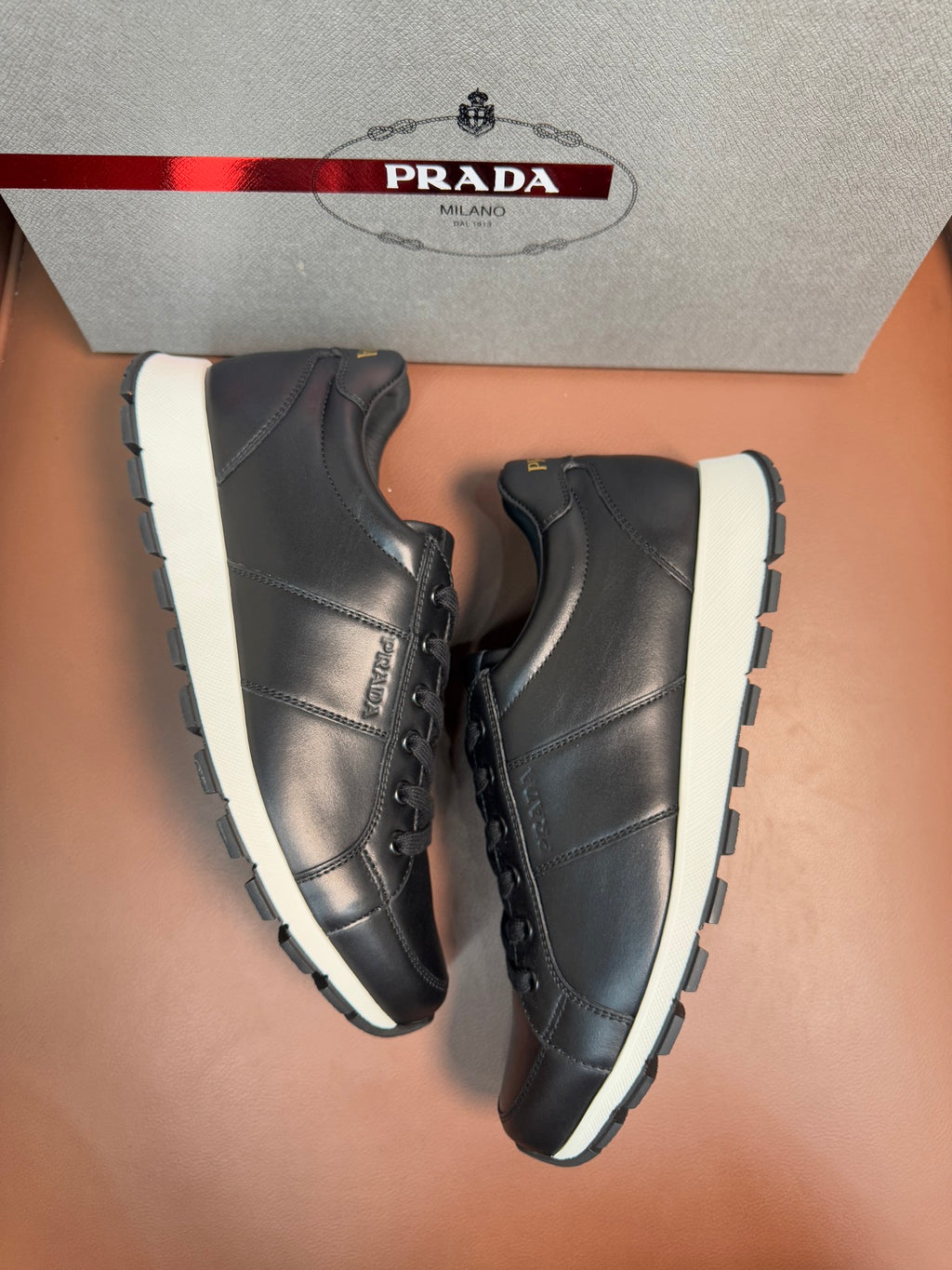 Prada unisex sneakers, dark leather lace-up shoes with white sole and side panel stitching