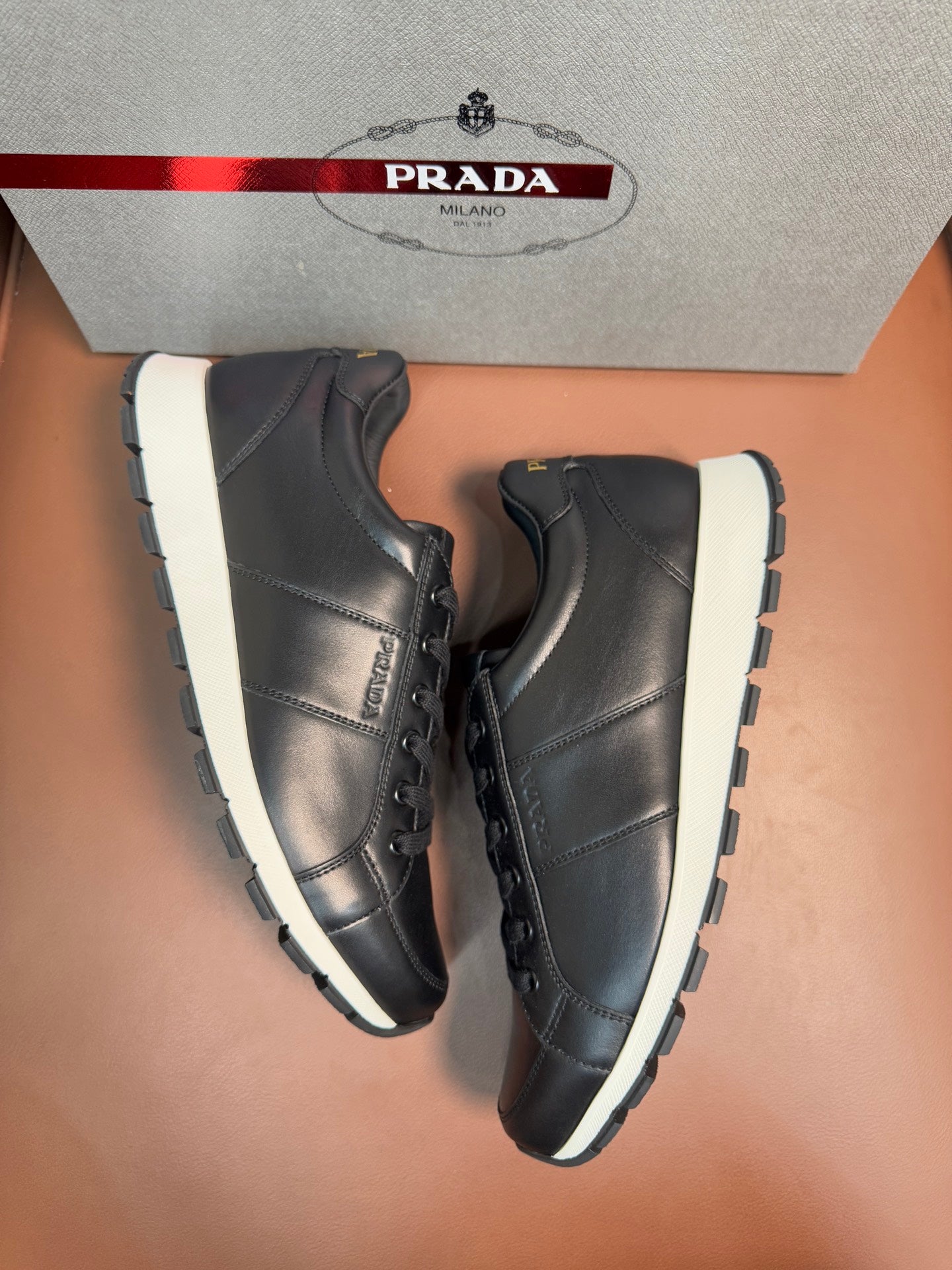 Prada unisex sneakers, dark leather lace-up shoes with white sole and side panel stitching