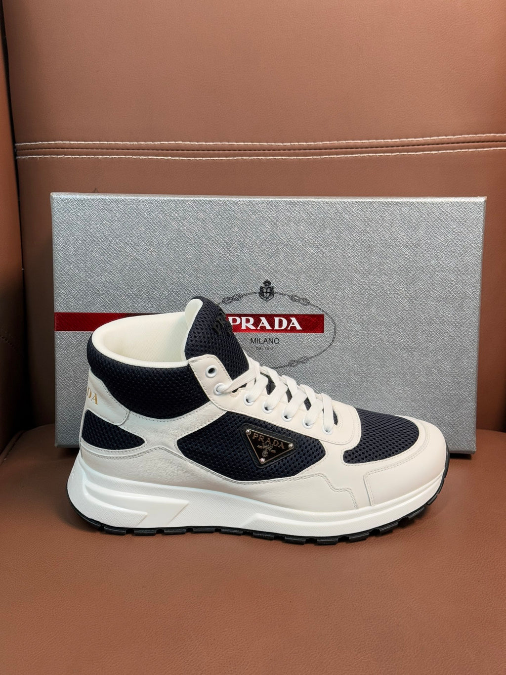 White and dark navy lace-up sneakers with logo patch on the side