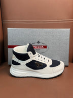White and dark navy lace-up sneakers with logo patch on the side
