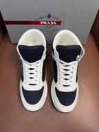 Lace-up sneakers in white and dark navy with chunky rubber sole