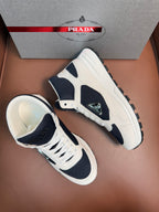 Pair of lace-up sneakers with white uppers and dark navy side panels
