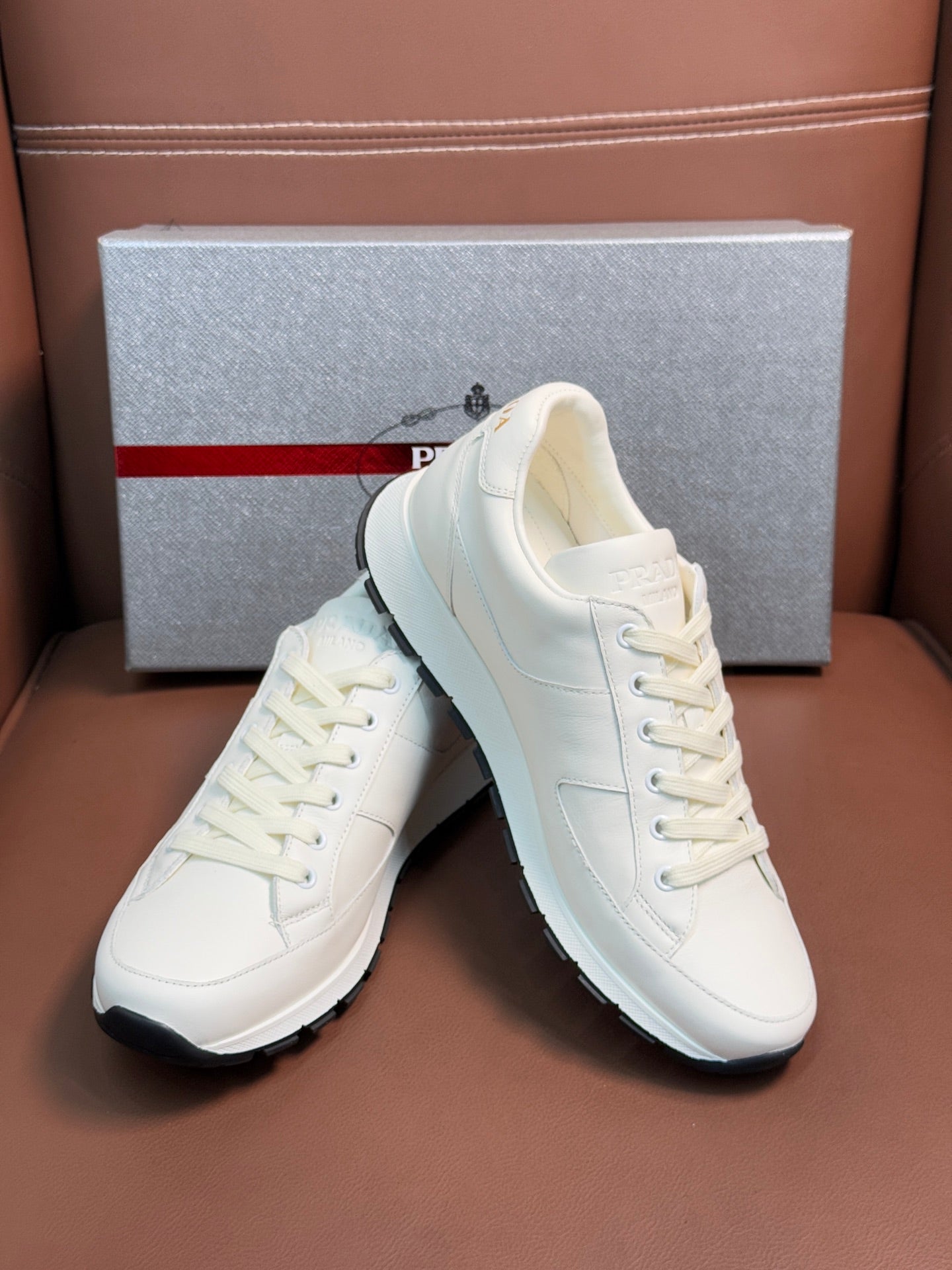 Prada unisex white sneakers with lace-up front and chunky sole