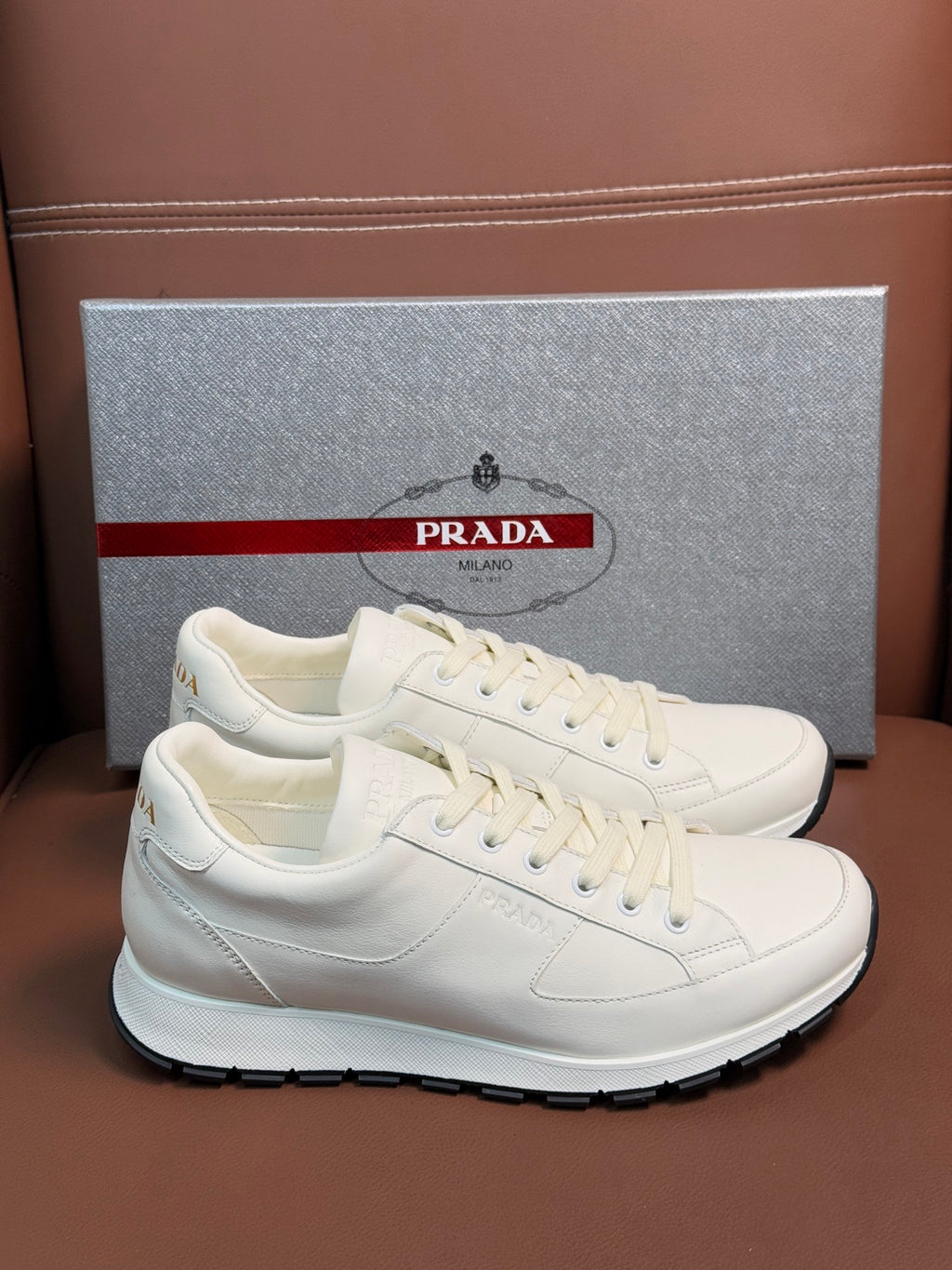 Prada unisex white low-top sneakers with lace-up and rubber sole