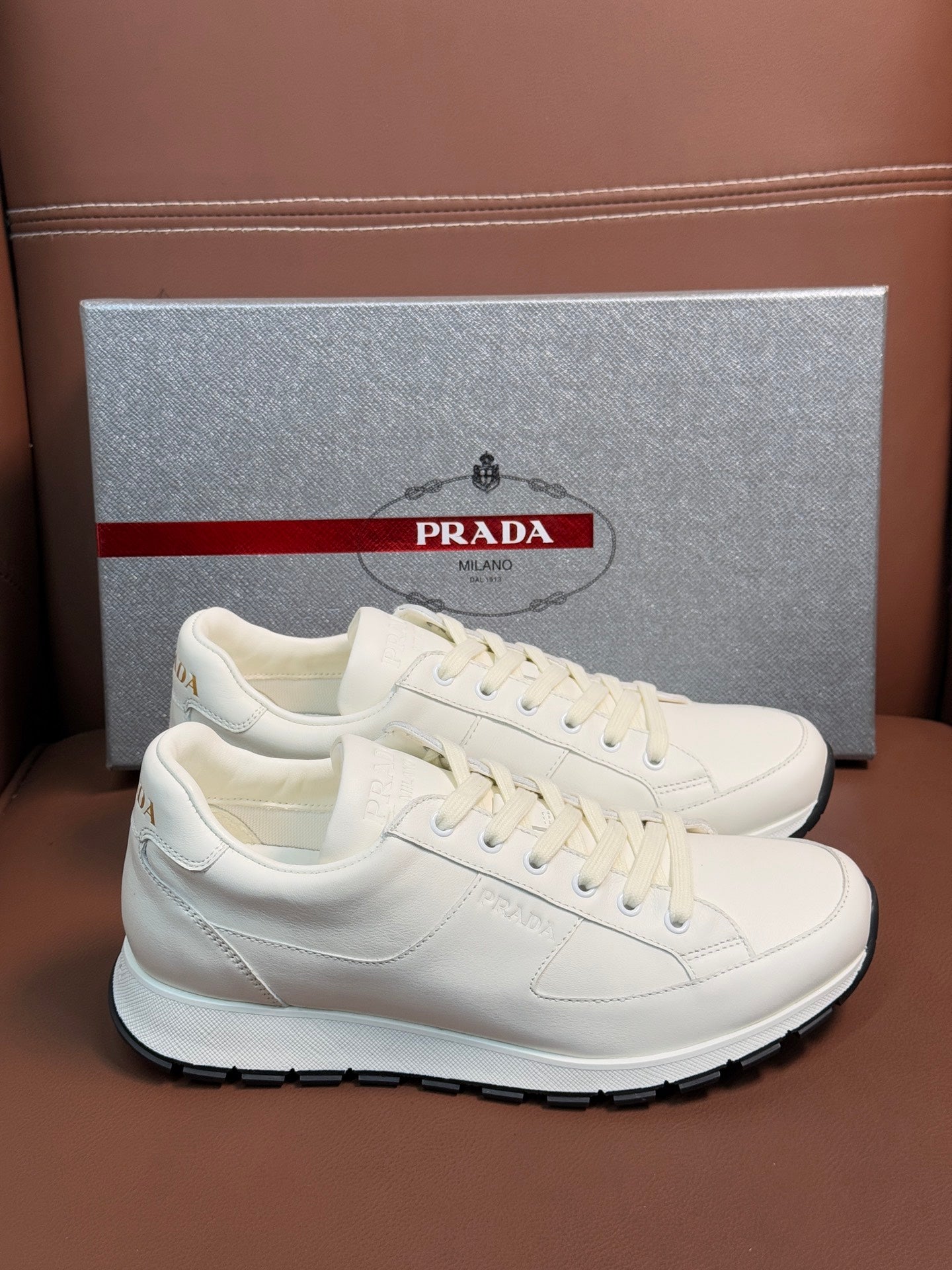 Prada unisex white low-top sneakers with lace-up and rubber sole