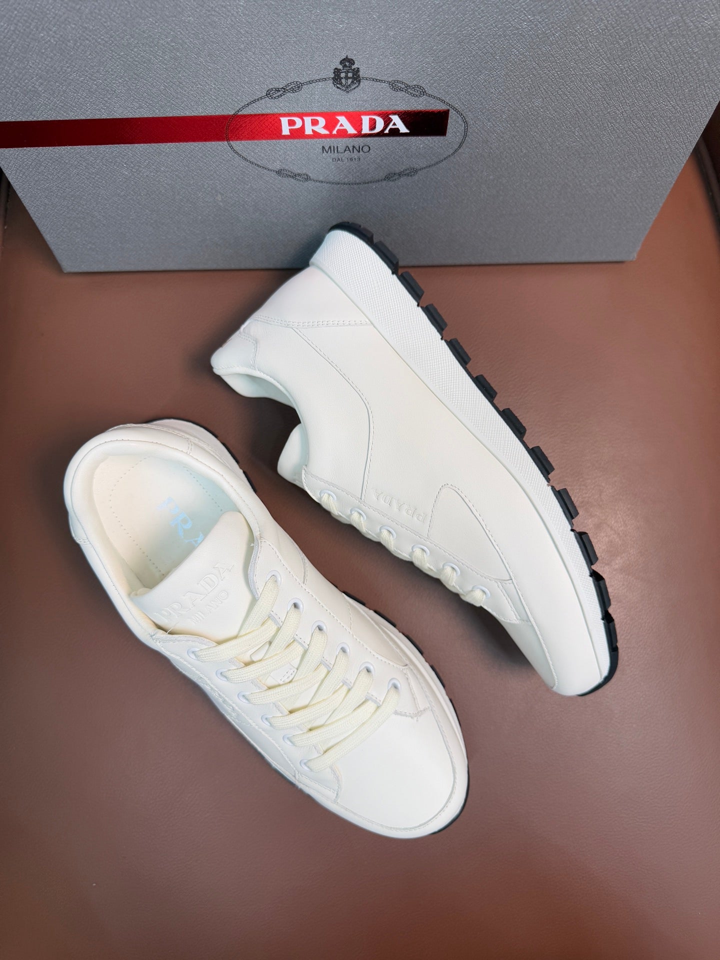 Prada unisex white sneakers, side and top view, lace-up