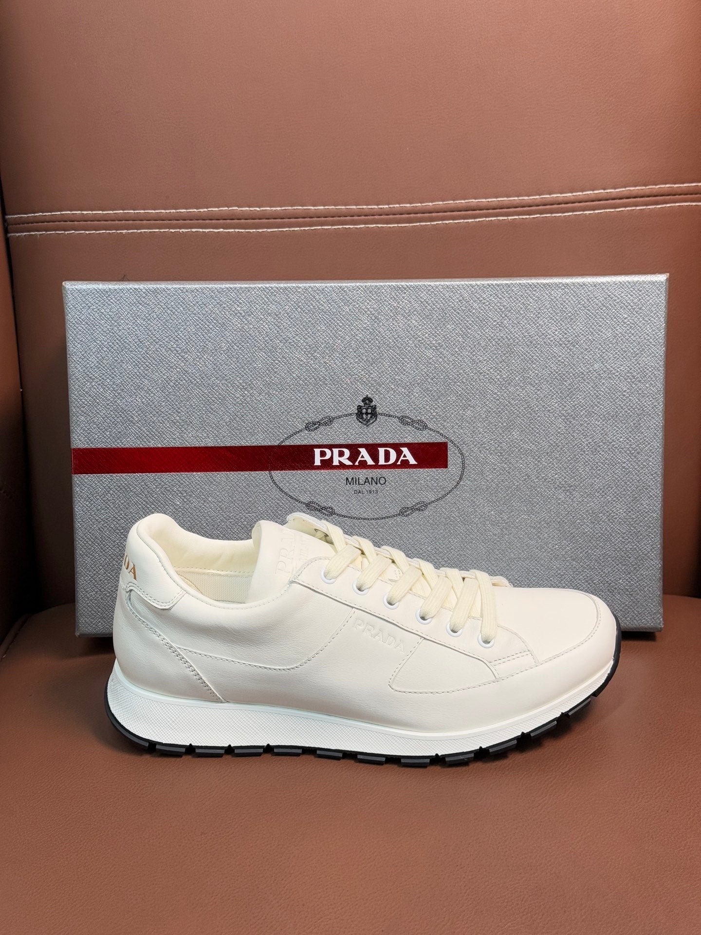 Prada unisex white low-top sneakers with lace-up, side view