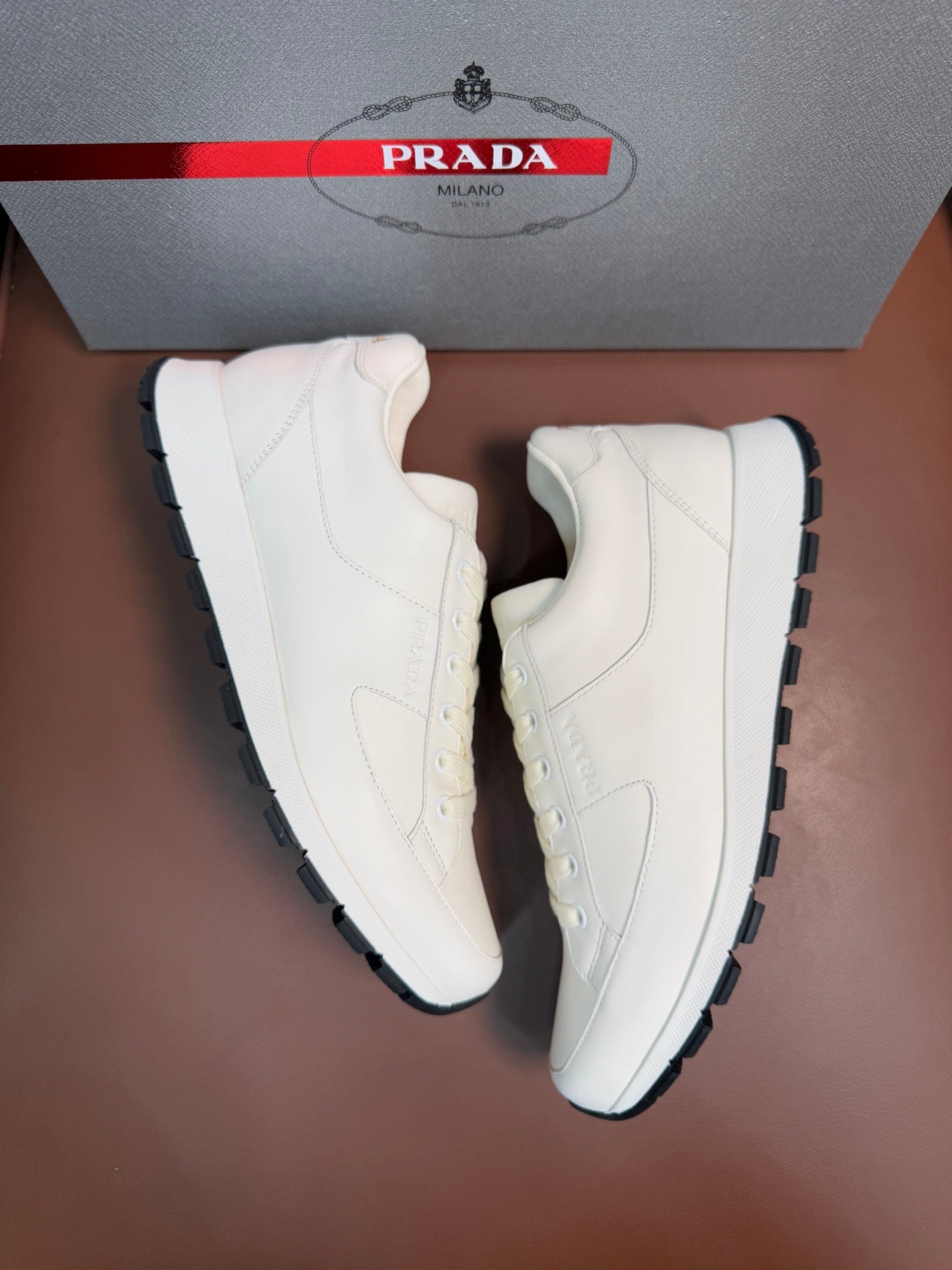 Prada unisex white sneakers with dark rubber sole, lace-up