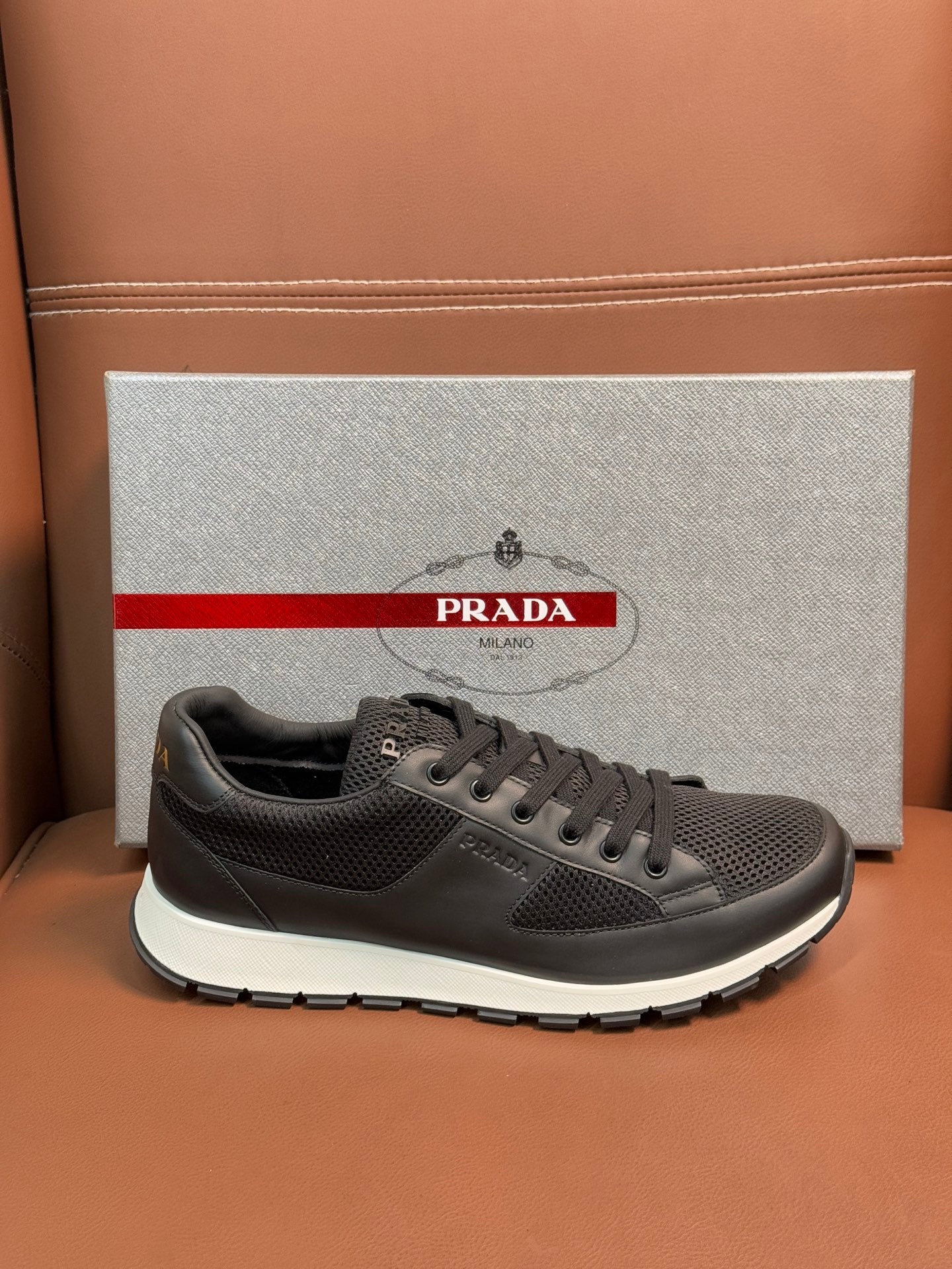 Prada unisex low-top sneakers, dark charcoal lace-up, smooth toe cap detail