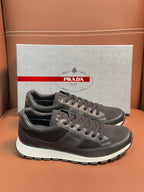 Prada unisex low-top sneakers in dark charcoal, lace-up with white rubber sole