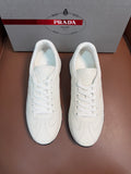 White leather low-top sneakers with white laces and cushioned tongue