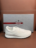 White leather lace-up sneaker with Prada logo on side and rubber sole