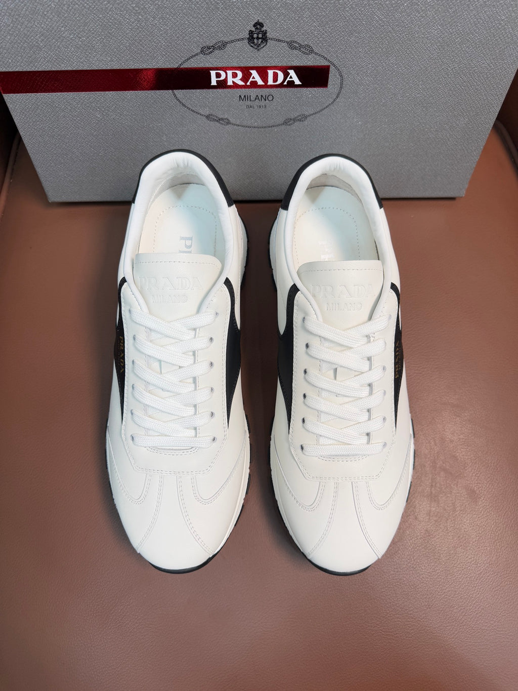 White leather unisex lace-up sneakers with Prada heel tab
