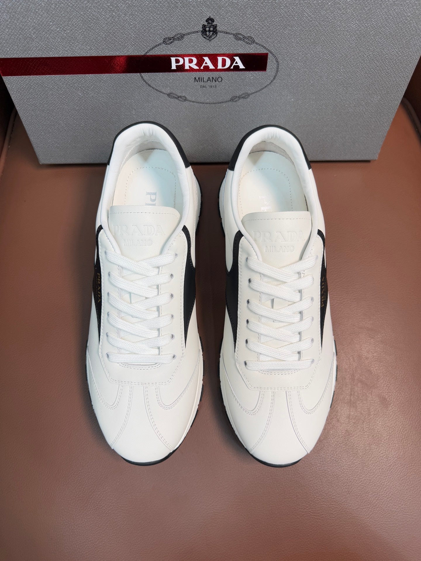 White leather unisex lace-up sneakers with Prada heel tab