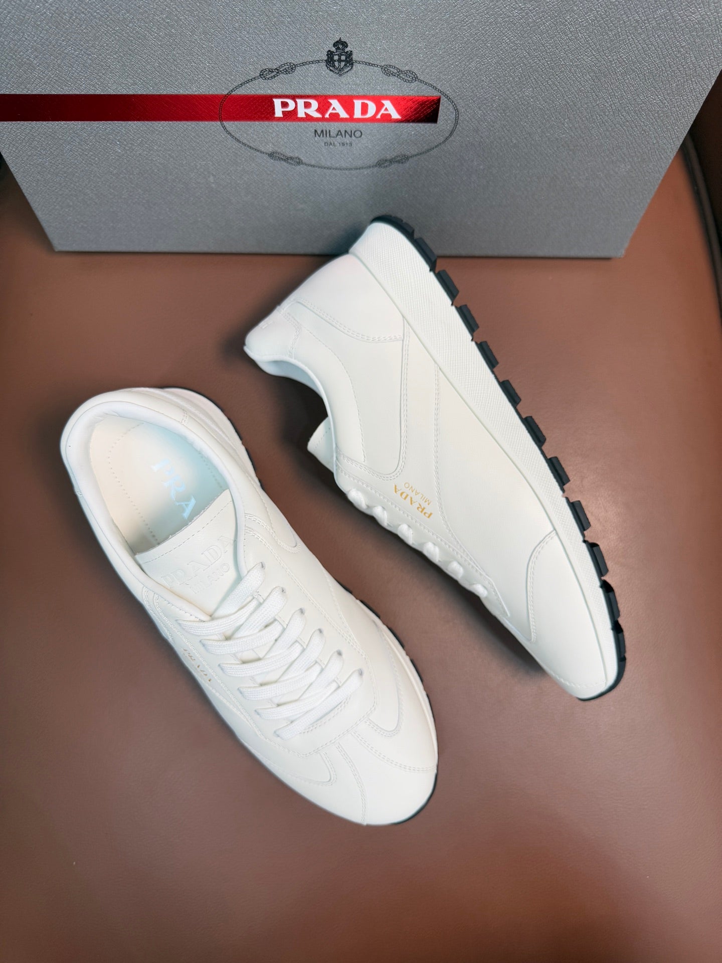 White low-top sneakers side views with white laces and rubber sole