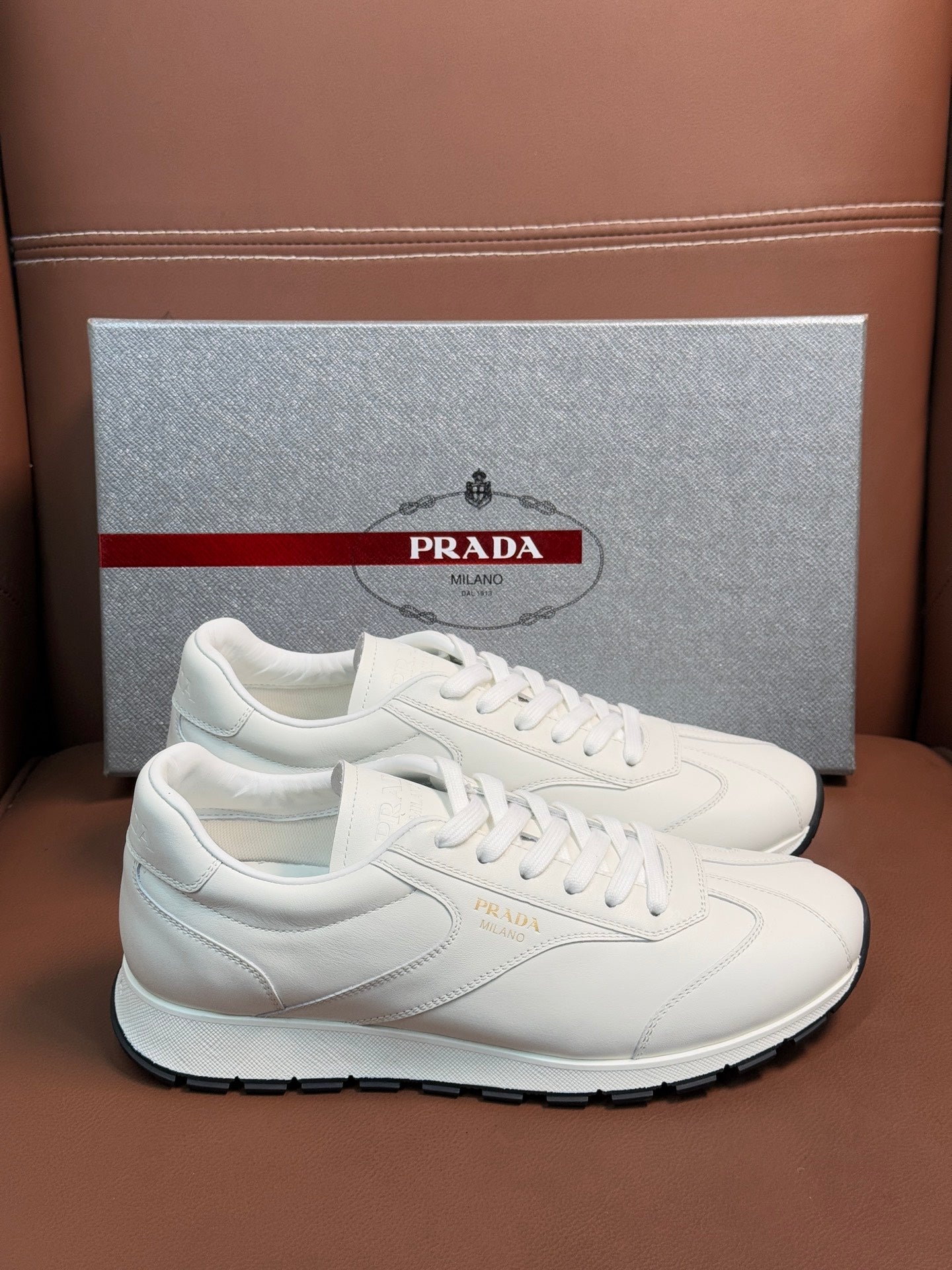 White low-top sneaker with lace-up front and rubber tread sole