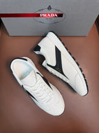 White unisex sneakers with black side swoosh and lace-up design