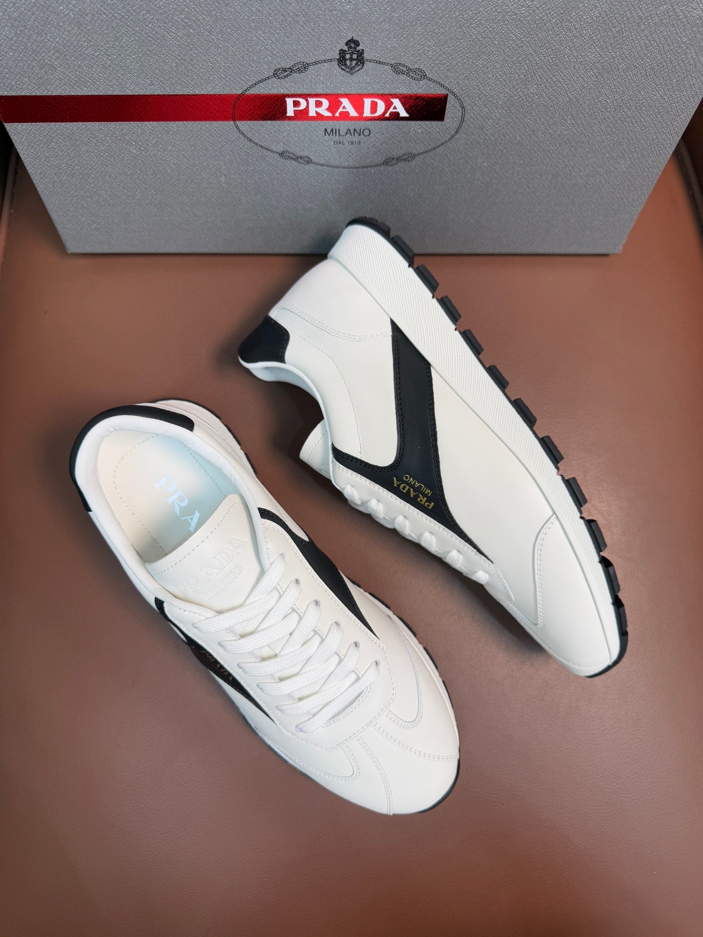 White unisex sneakers with black side swoosh and lace-up design