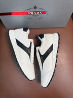 White unisex sneakers with black quarter panels, lace-up closure
