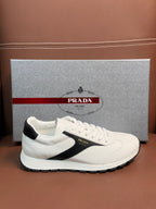 White unisex sneakers with black side stripe and lace-up eyelets