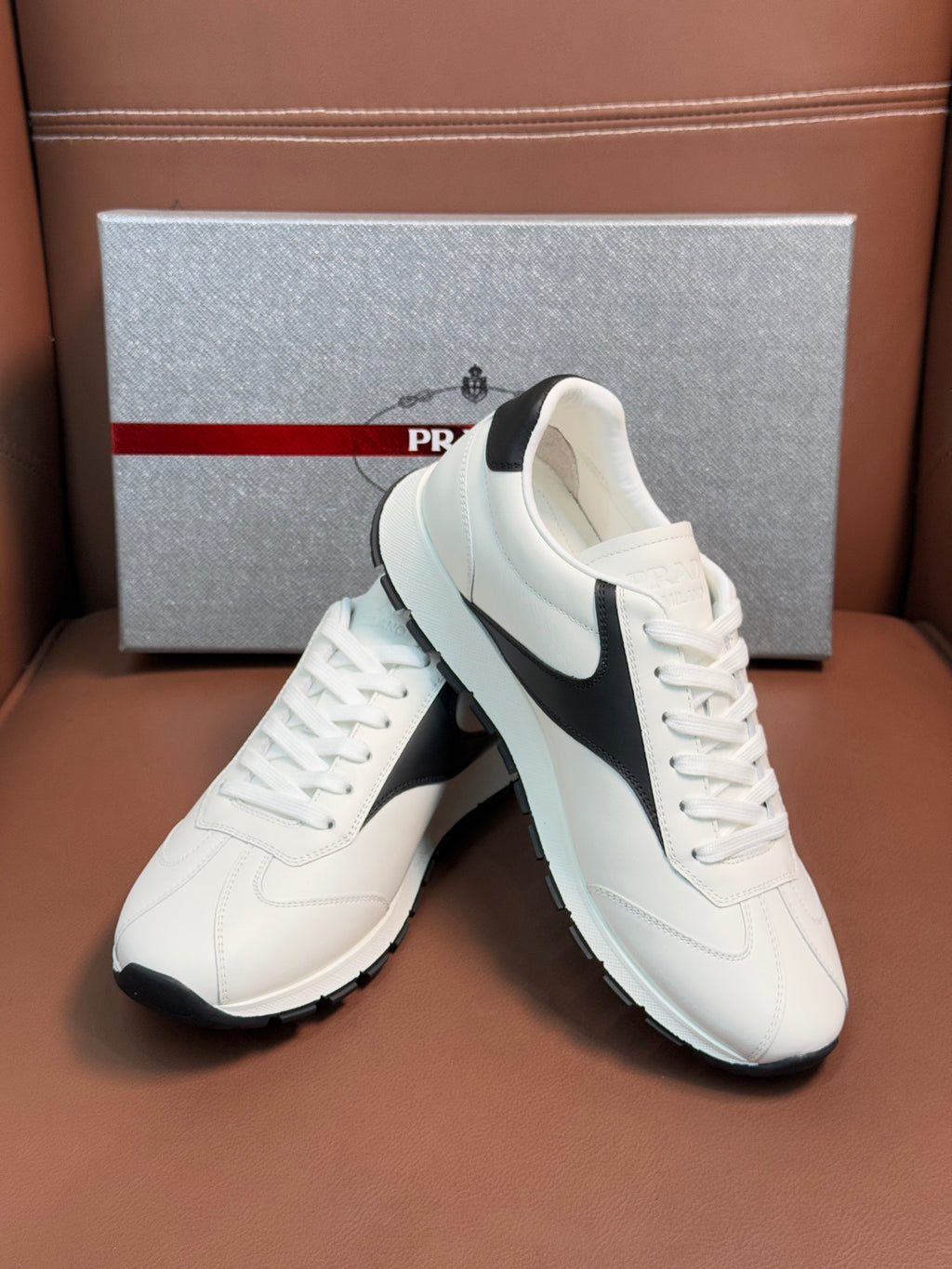 White unisex sneakers with black side stripe and lace-up front